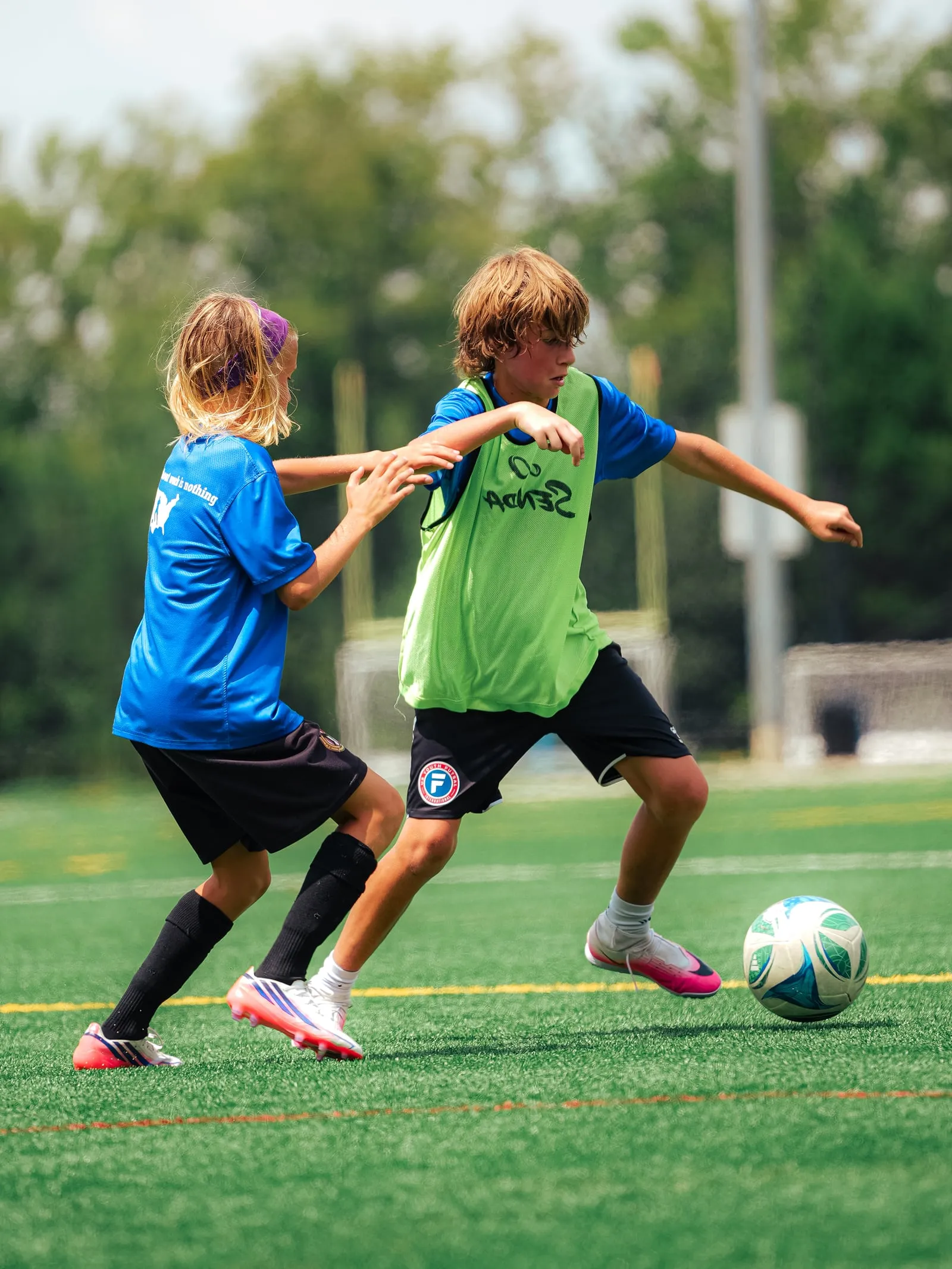 Two players contesting the ball during a Phenom Elite training session