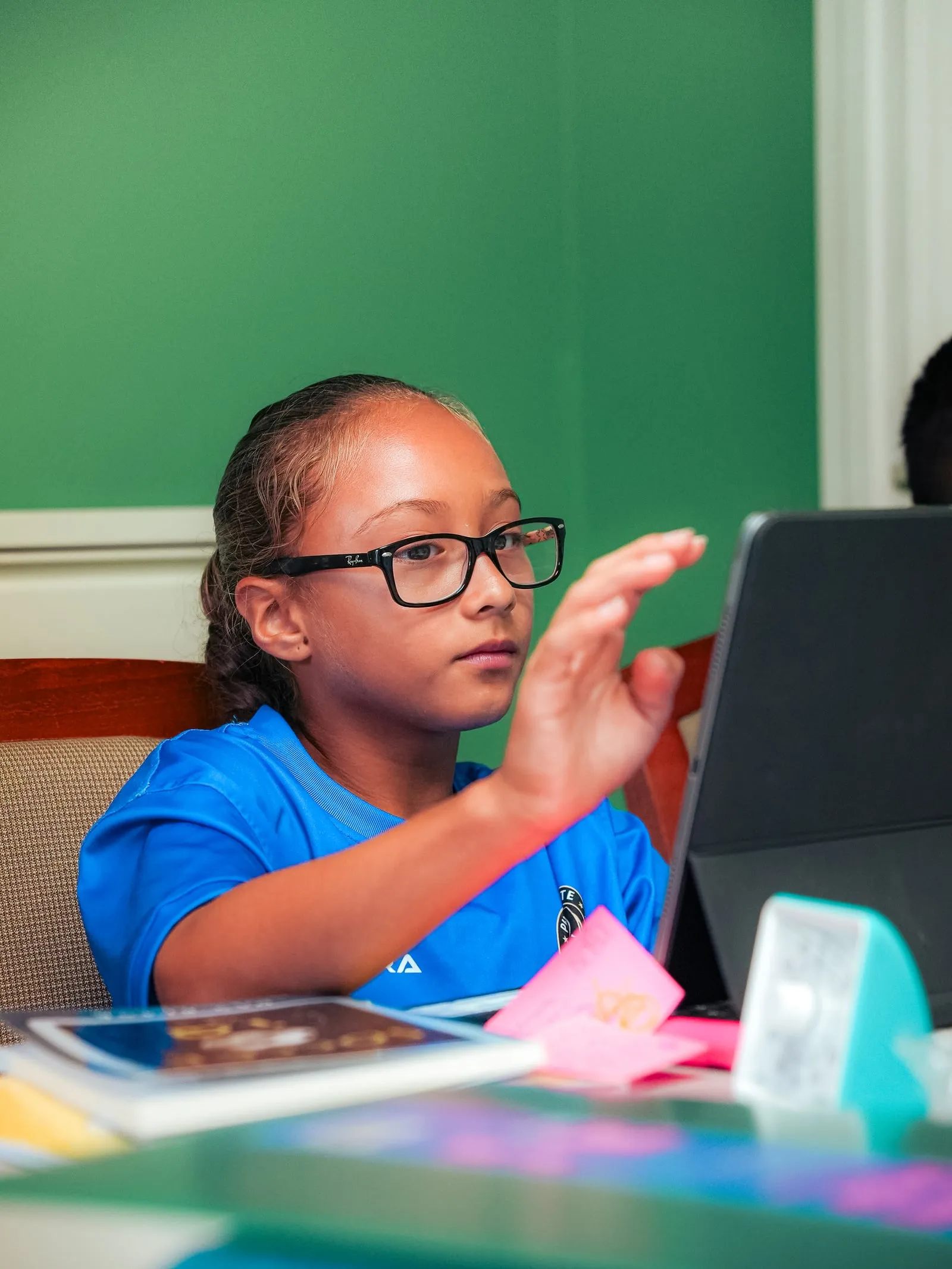 A player raising her hand with a question during a learning-lab session