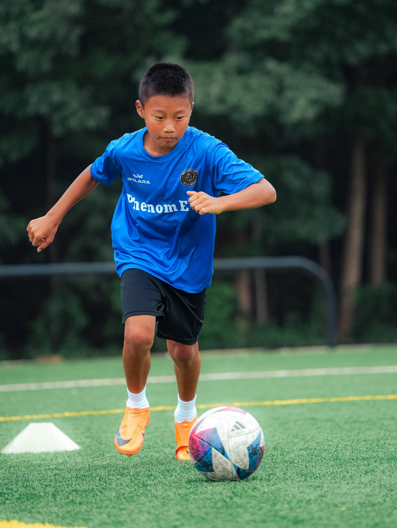 A player keeping the ball close through a cone drill
